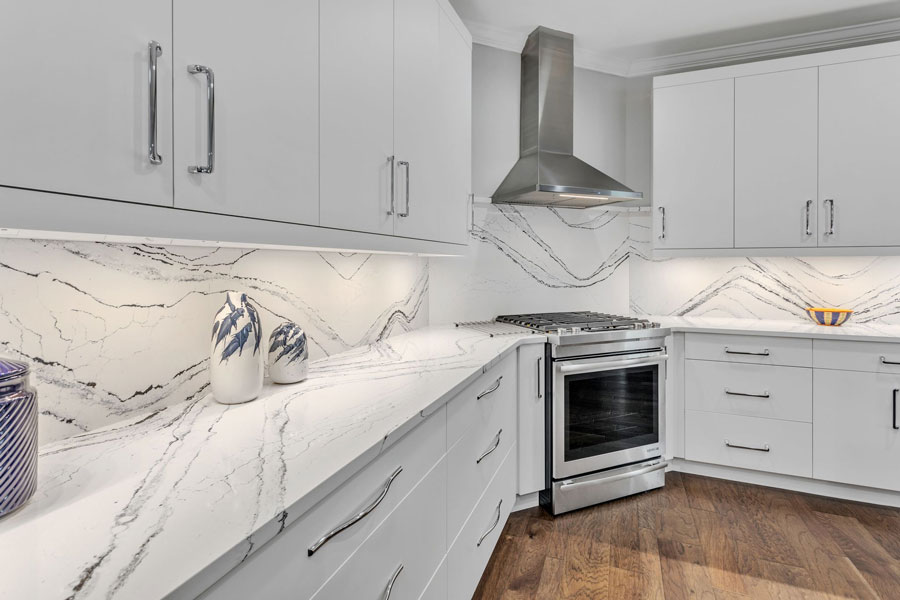 Sleek Modern White Kitchen Cabinets with Quartz Backsplash and Countertops