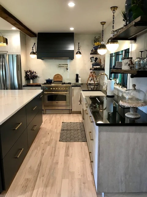 Wood cabinets and contrasting countertops in a farmhouse kitchen design