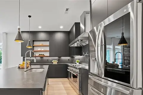 All matte black kitchen with contrasting stainless steel appliances