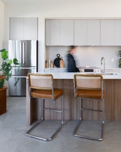 Contemporary kitchen with stylish light gray cabinets and wooden accents